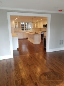 New oak floors in kitchen, older floors on rest of the house. One coat of antique brown stain and three coats oil base satin.