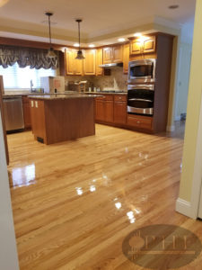 Dustless refinishing with three coats oil base satin. The floors look extremely shiny because the finish was wet when the photo was taken.